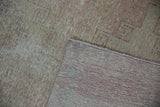 Distressed Oushak rug pile showing wear, visible knot heads, and hand-knotted reverse.