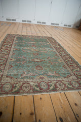 Distressed vintage Kayseri rug: ocean green field, arts and crafts florals, and heavy abrashes.