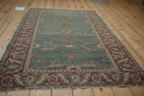 Visible wear and abrashes on the ocean green field and detailed cherry red border.