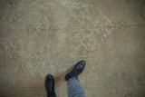 Distressed vintage Oushak rug texture and soft palette underfoot, showing even wear.