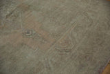 Muted sage green and dusty sandalwood pile, showing distressed wear to knot heads.