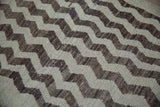 Textured cream and rich brown chevron pattern detail on a vintage distressed Tulu rug.