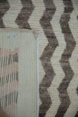 Vintage Tulu rug's woven back showing distressed cream and dark brown chevron pile.