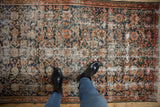 Distressed Hamadan rug with faded Herati motifs, revealing light foundation and muted color palette.