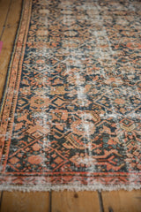 Detail of distressed Hamadan rug showing Herati pattern, worn pile, and exposed foundation in dusty blue and antique ivory.