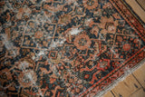 Vintage Hamadan rug detail: distressed Herati pattern, worn pile, and exposed ivory foundation.