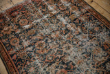 Worn red, blue Herati motifs and exposed antique ivory foundation on a distressed Hamadan rug.