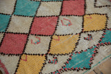 Textured pile showing vintage Moroccan harlequin diamonds in ivory, pink, saffron, and turquoise.