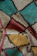 Harlequin diamond pattern in ivory, saffron, dusty pink, and pale turquoise pile.