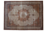 Fine distressed Sivas carpet with starburst medallion, sprawling vinery in rust, ivory, navy.