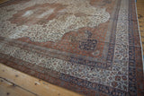 Distressed vintage Sivas corner, ivory field vinery and rust-navy palmette borders.