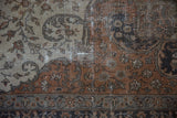 Distressed vintage Sivas carpet detail: sprawling vinery, palmettes, and visible foundation wear in earthy tones.