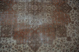 Distressed field pattern with vinery, palmettes, and exposed foundation in rust and ivory.