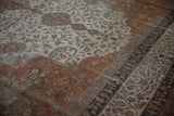Traditional distressed vintage Sivas carpet detail with ivory field and rust floral border.