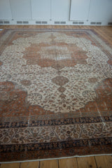 Distressed Turkish Sivas carpet border with navy, coffee brown, and ivory vinery, blossoms, and palmettes.