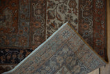 Distressed vintage Sivas carpet, corner folded, revealing worn pile, visible foundation, woven back, and fringe.