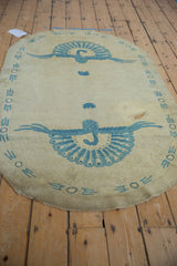 Rounded Art Deco rug corner, featuring blue geometric border elements and a visible spot treated stain.