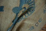 Hand-knotted pile texture and dusty denim blue geometric border on the vintage Art Deco rug.