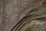 Detailed texture of vintage Kayseri rug with time-softened dusty red and ivory floral patterns.