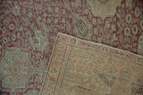 Distressed vintage Kayseri rug with dusty red pile and visible hand-knotted foundation.