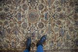 Distressed Isfahan rug: soft apricot, blue, brown lotus flowers and vinery underfoot.