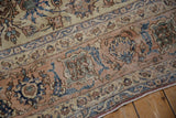 Distressed texture reveals intricate Isfahan vinery, faded apricot, navy, and ivory floral motifs.