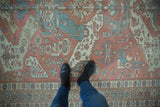 Distressed Soumac design carpet with dragon style geometric motifs and starburst pomegranate border in blush, blue.