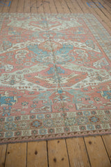 Vintage Soumac rug's geometric starburst, wave border in dusty blush, pale blue.