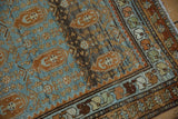 Vintage Distressed Malayer rug corner, starburst border with playful color fills, and blue field.