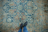 Softly distressed vintage Northwest Persian rug with powder blue and dusty gold floral motifs.