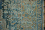 Distressed Northwest Persian rug border with nuanced floral palmettes in blue and dusty gold.