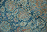 Subdued sapphire blue, terracotta, and gold palmettes on the distressed Northwest Persian carpet.