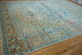 Corner detail of the distressed terracotta and powder blue main border with floral motifs.