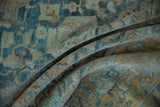 Folded vintage Northwest Persian carpet with soft sapphire blue and sandy gold distressed pile.