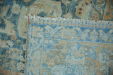 Distressed pile in powder blue and dusty gold, revealing hand-knotted foundation and fringe.