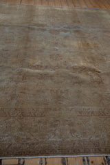Distressed gold and aubergine floral motifs on vintage Sivas carpet texture.