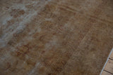 Distressed vintage Sivas carpet, showing foundation threads and faded aubergine floral motifs.
