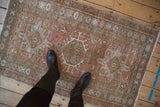 Distressed vintage Karaja rug with geometric medallion motifs in dusty rose and blue.
