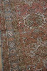 Distressed vintage Karaja rug texture with dusty rose and pale denim blue geometric patterns.
