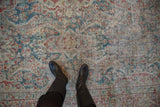 Distressed Persian Mahal carpet with millefleur lattice and sapphire, black cherry, ivory tones.