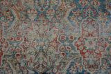 Distressed Mahal carpet, worn pile with visible foundation, featuring dusty blue and red millefleur motifs.