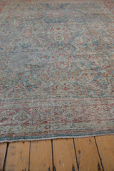 Distressed pile and secured fringe of the vintage Mahal carpet, showing dusty blue and cherry red.