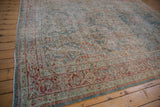 Vintage distressed Mahal carpet corner with worn sapphire blue and black cherry red pattern.