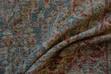 Distressed Mahal carpet close-up, revealing worn pile texture and faded blue, red lattice floral designs.