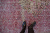 Distressed fuchsia Herati pattern contrasts with the ivory and teal medallion corner.