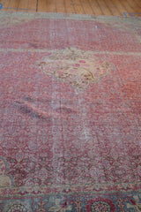 Distressed texture on a vintage Kayseri carpet with a dusty fuchsia Herati motif and visible abrashes.