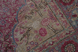Worn texture on a vintage Kayseri corner, showing fuchsia and charcoal tree of life details.