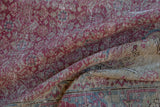 Detailed view showing the woven foundation and distressed fuchsia pile of a vintage Kayseri carpet.