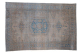 Distressed Persian Veece carpet with a large blue medallion and geometric patterns in soft platinum tones.