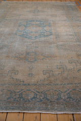 Faint foundation showing through the evenly worn low pile of a distressed Veece carpet.